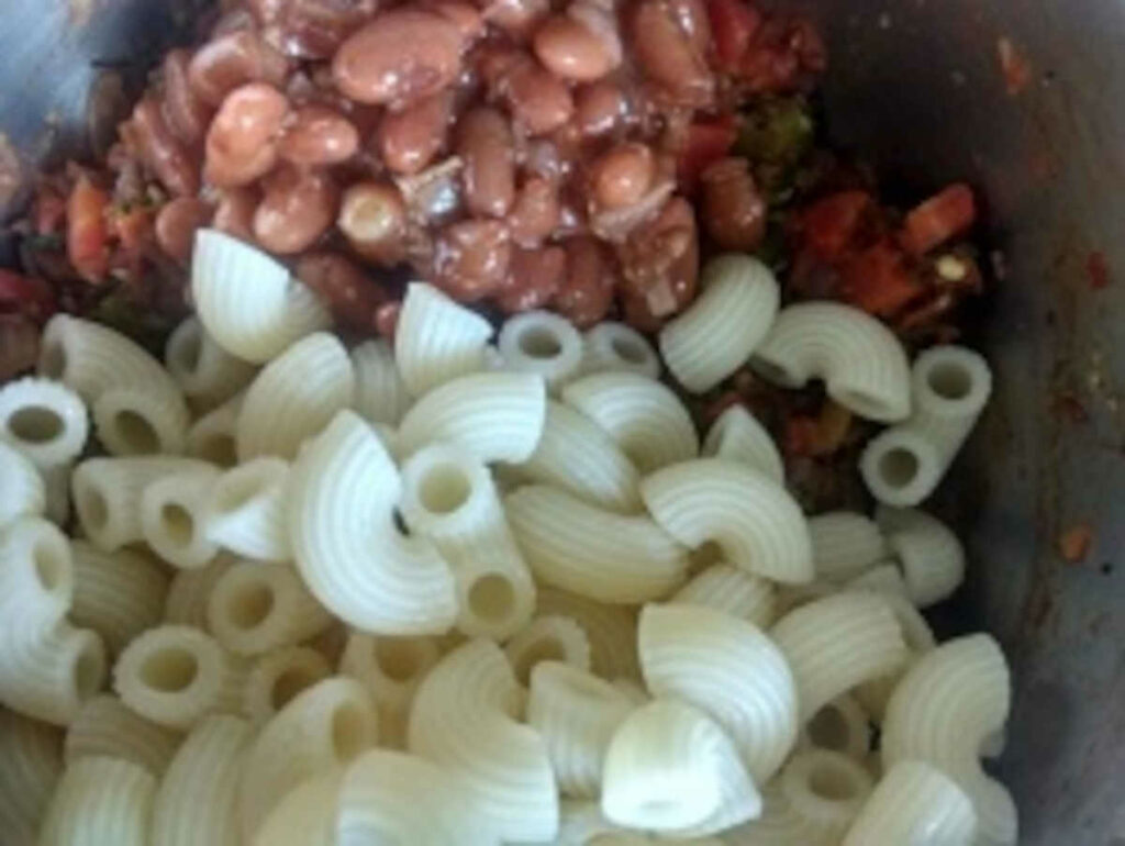 add cooked pasta and kidney beans to veggies for minestrone italian soup