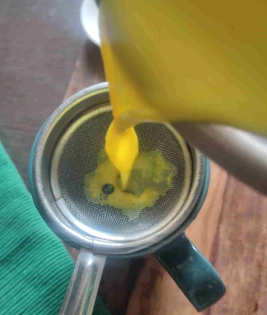 sieving the turmeric milk