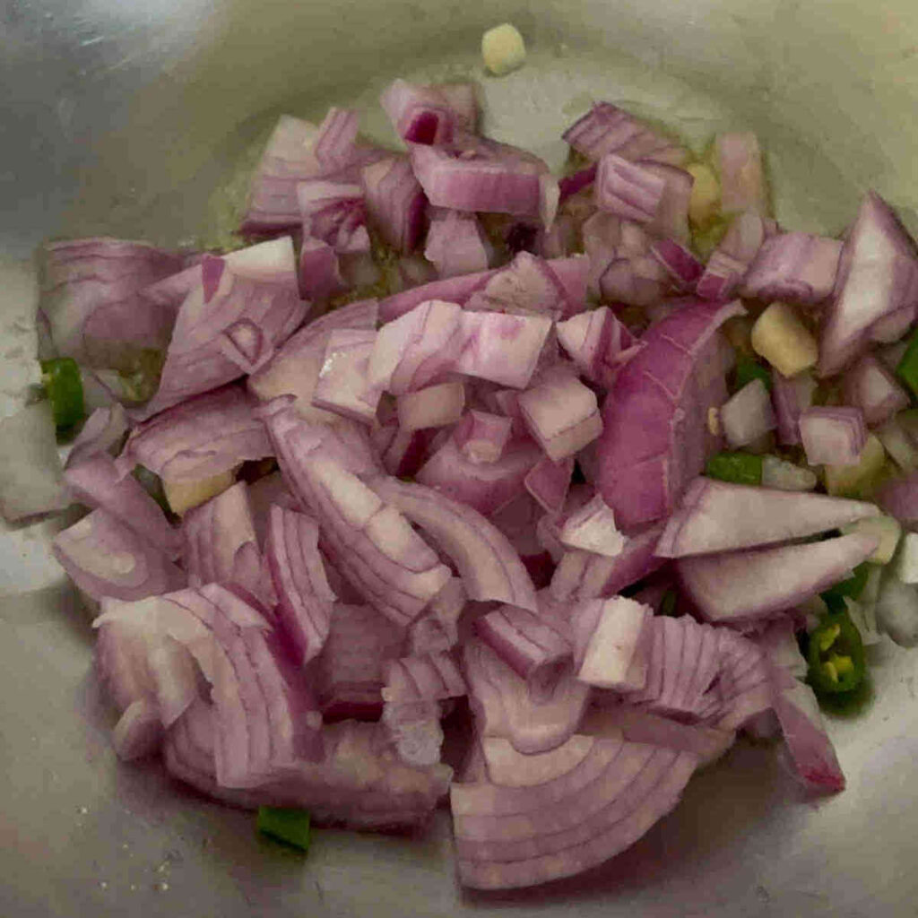 add onions to mustard seeds in wok for tempering quinoa
