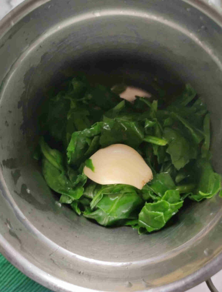 add garlic and blanched (cooled) spinach leaves
