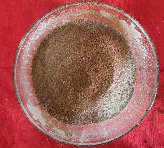 adding flour, cocoa powder and baking soda to wet ingredients mixture for chocolate muffin