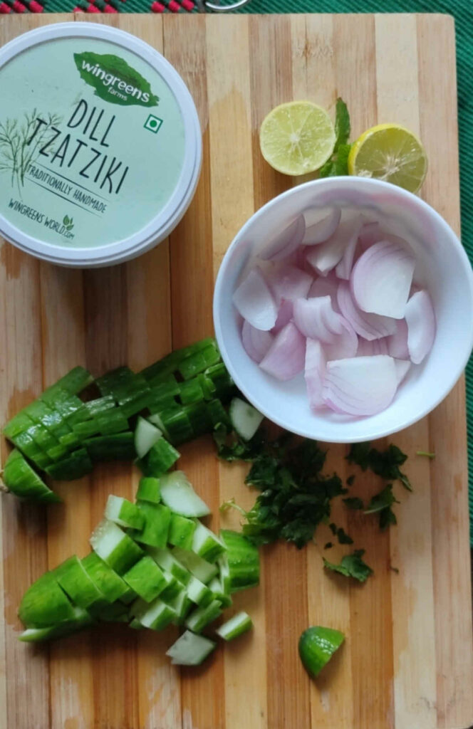 chop cucumber, mint and onion for cucumber salad