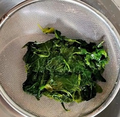 bathus boiled leaves in colander