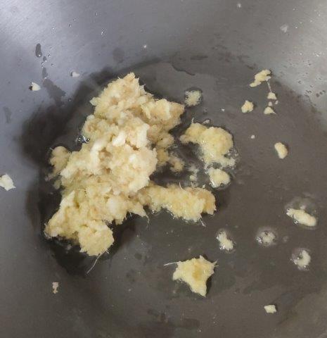 sauteing ginger garlic paste in ghee in a pan