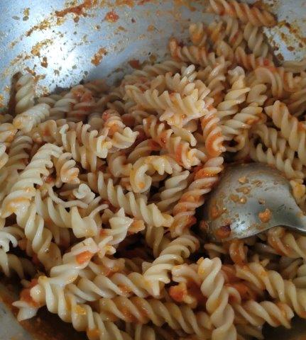 Mixing pasta with sauce
