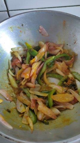 add spices to cooked onion capsicum for mushroom masala