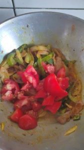 tomatoes added to onion capsicum