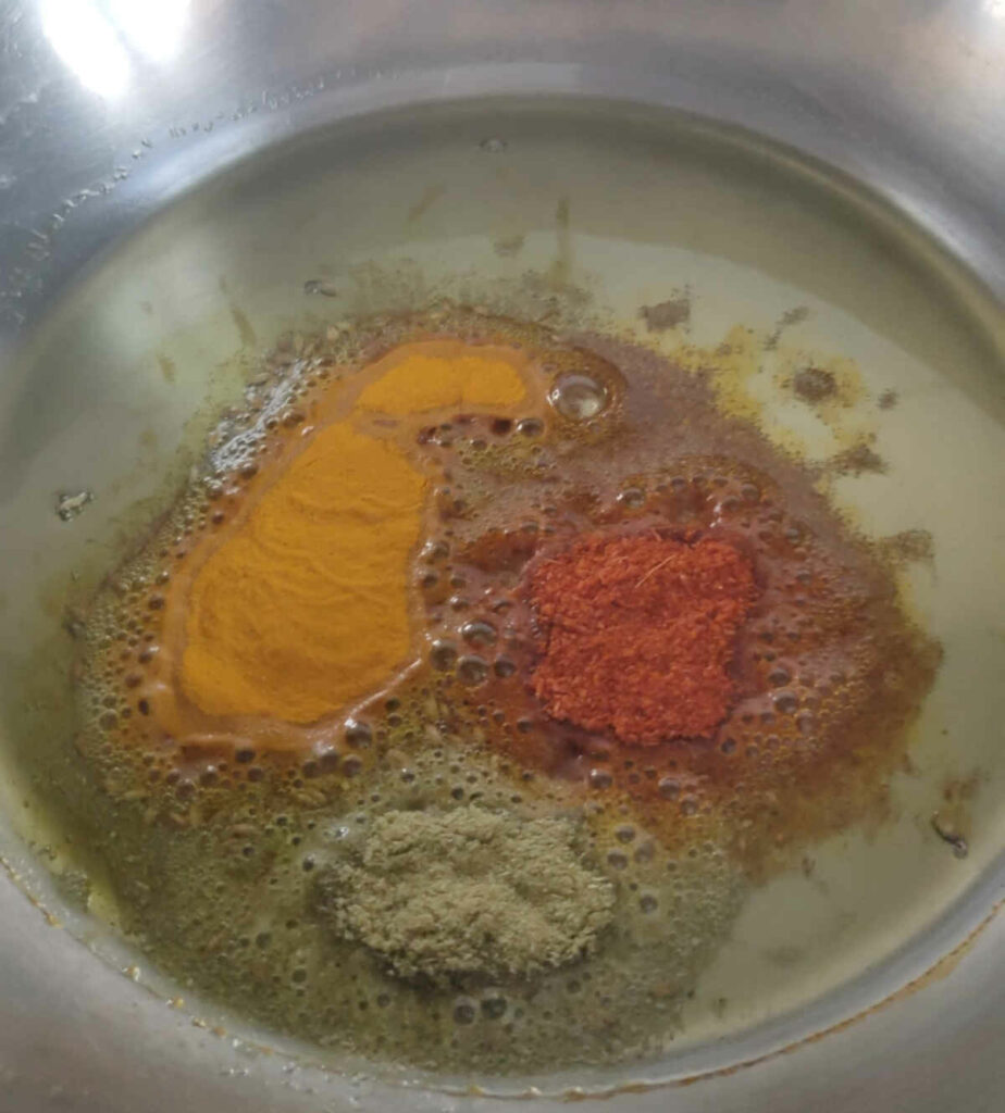 spices in mustard oil for making beans potatoes