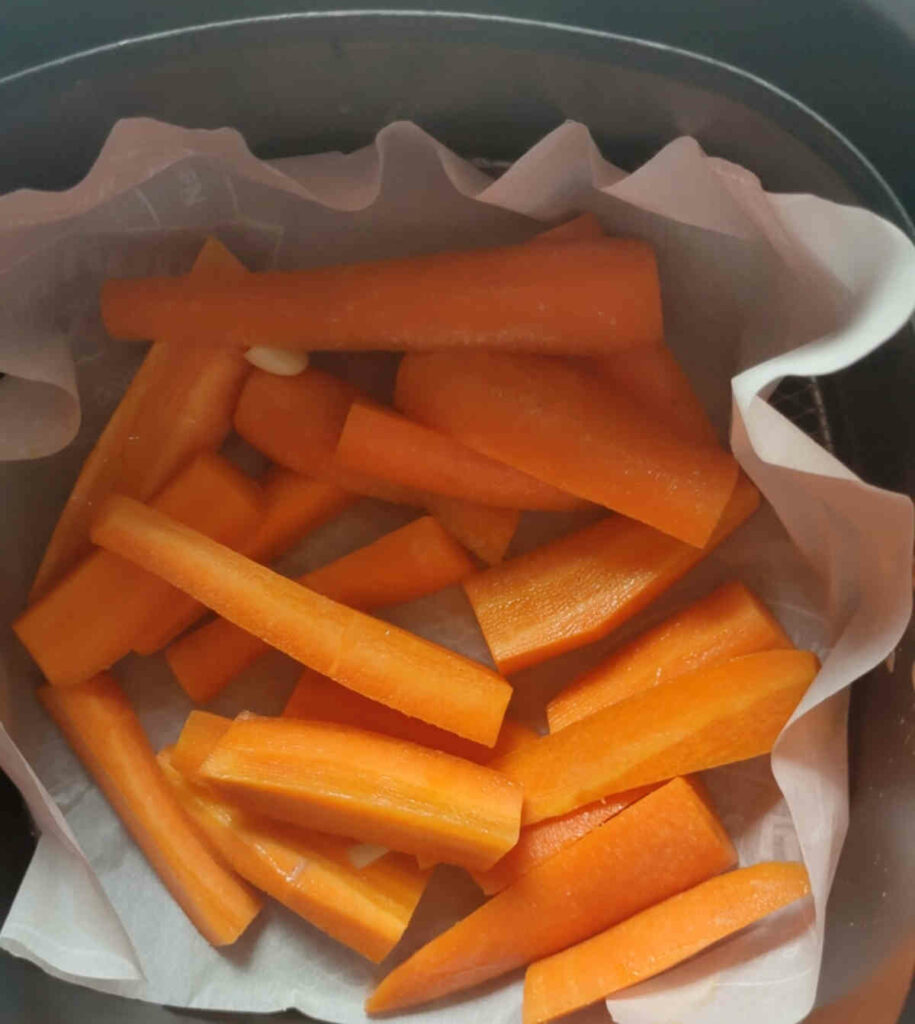 place coated carrots in air fryer basket for making fries
