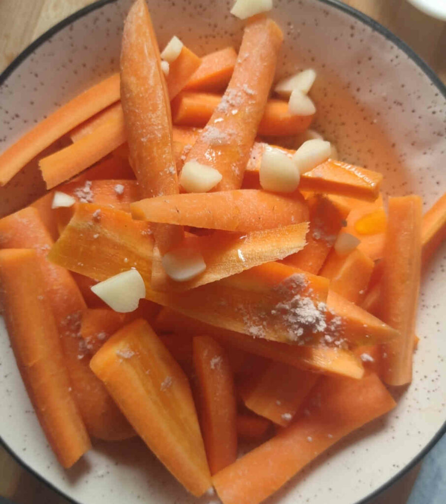 coat chopped carrots and garlic with olive oil, salt in a bowl for air frying carrots