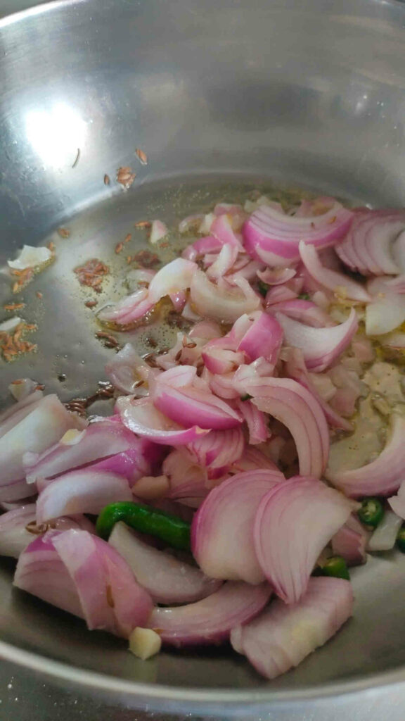 add onions, garlic, green chilly to cumin for mushroom stir fry