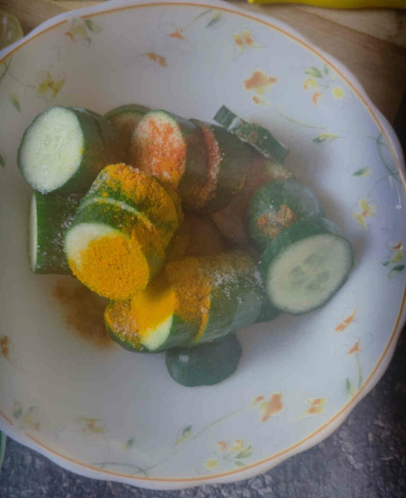 mix cucumbers with salt spices oil in bowl for fritters