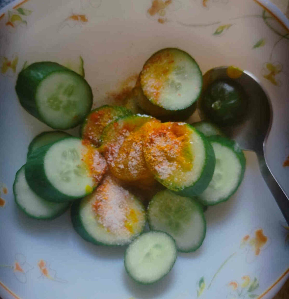 sliced cucumbers topped with salt, spices and olive oil for air frying