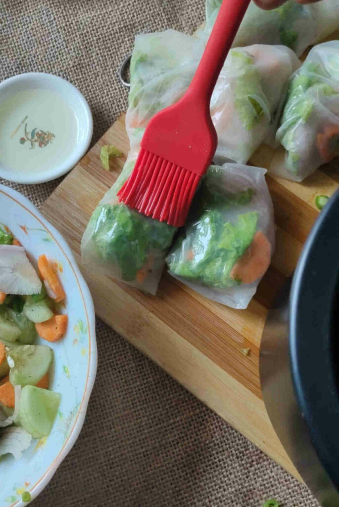 brush the rice paper rolls with olive oil