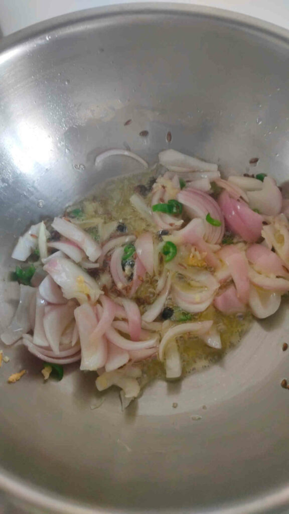 onion garlic green chilies added to wok 