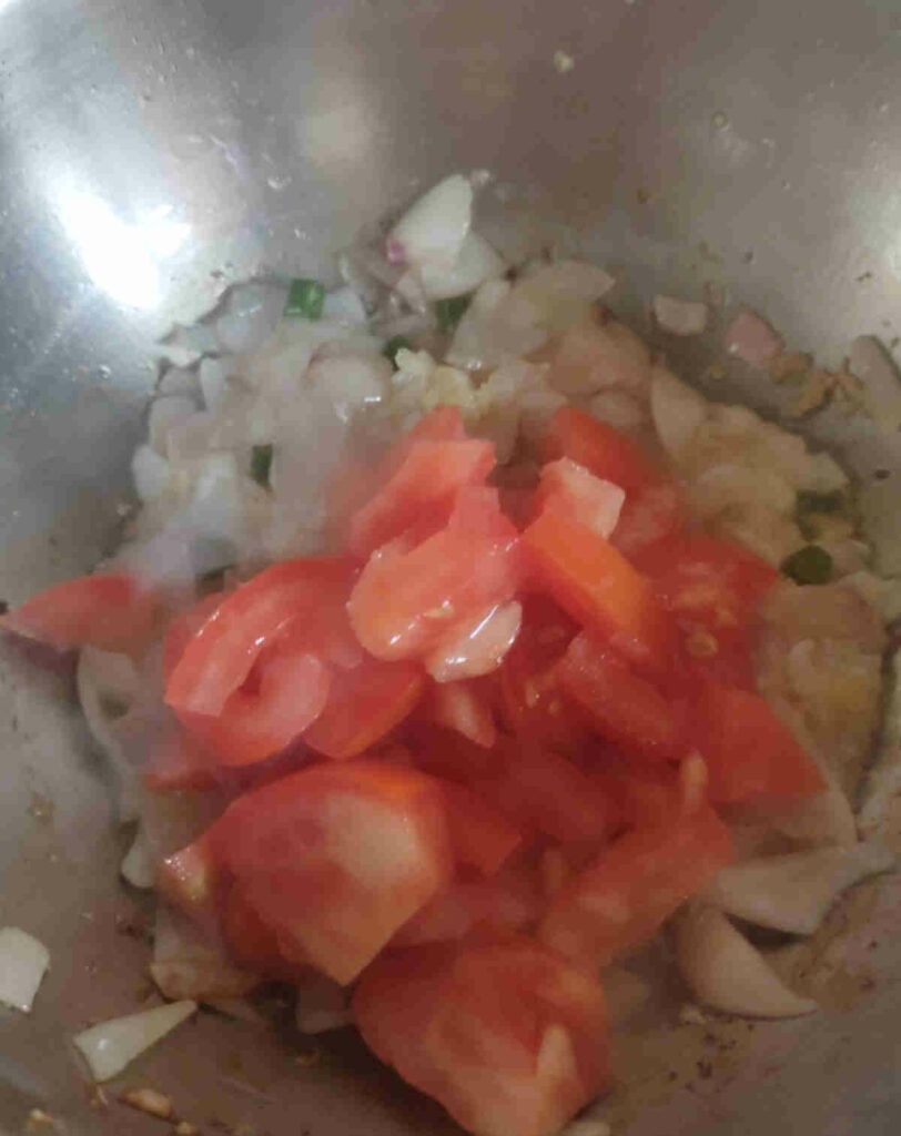 add tomatoes to the cooked onions