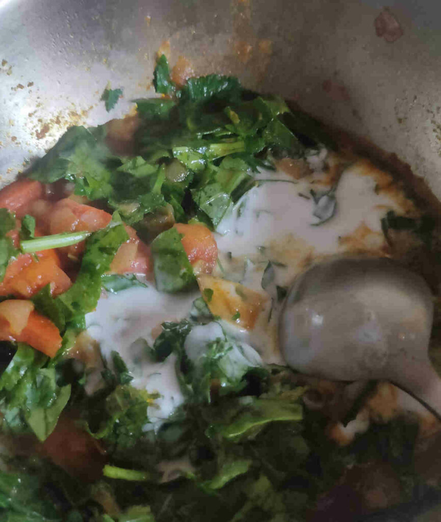 add coconut milk to almost cooked leafy greens chana saag