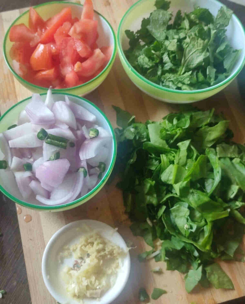 chopped spinach, onion, tomato, garlic for chana saag