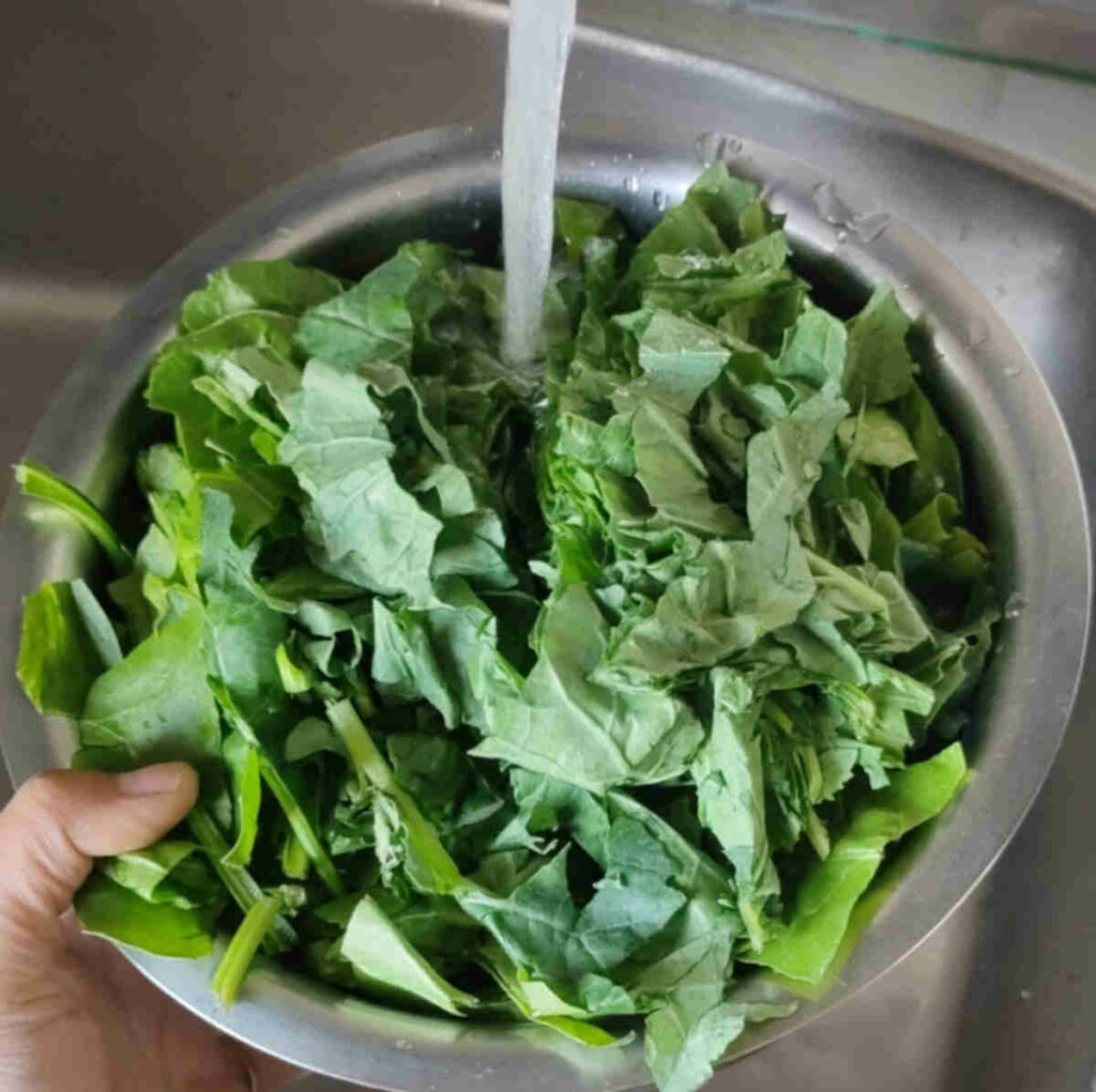 rinse the chopped greens in a bowl of water