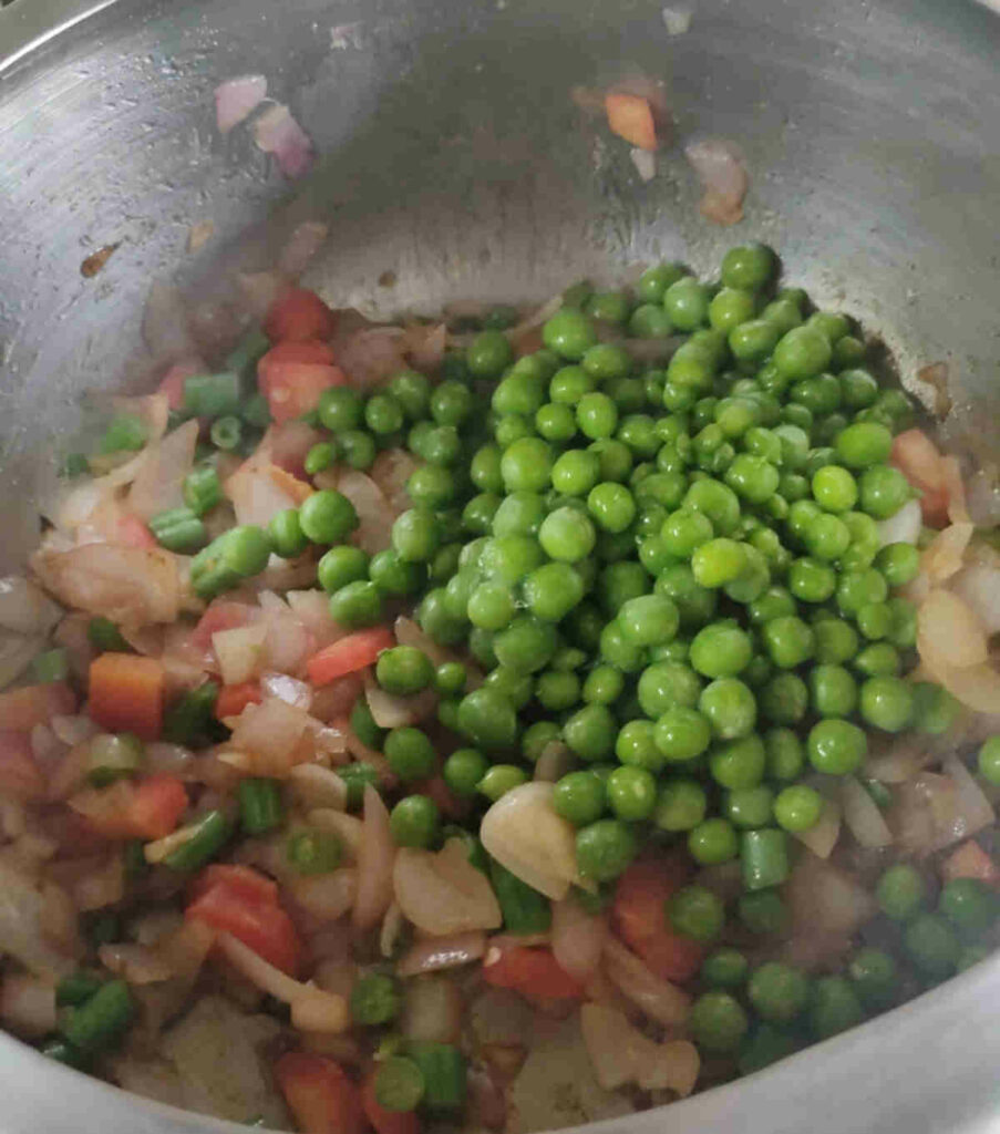 add green peas and soy sauce to veggies