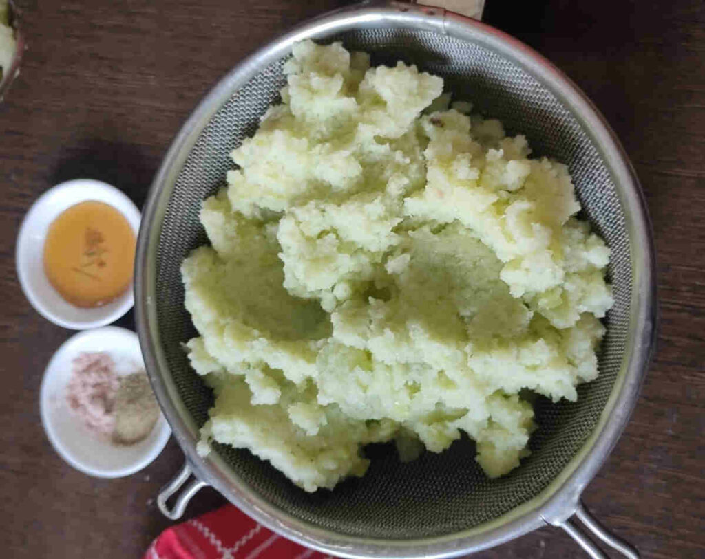 place the amla paste in a fine-mesh strainer